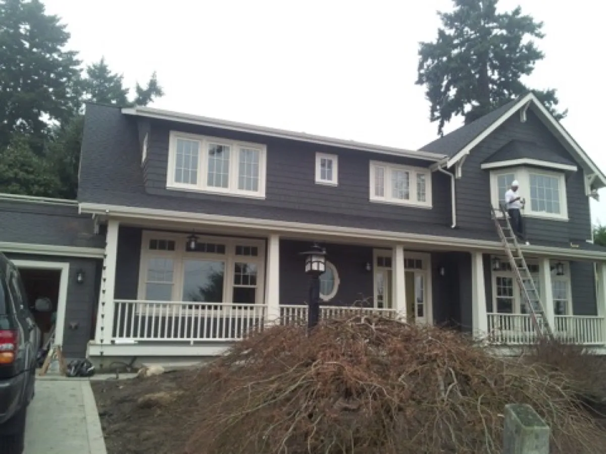 Exterior painting by All Custom Building — dark colonial with white trim