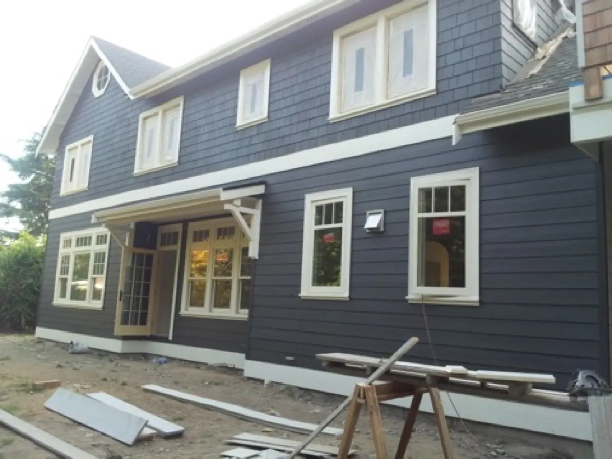Siding installation by All Custom Building — navy exterior with white trim
